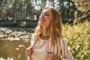 Woman smiling after figuring out how long it takes to detox from drugs.
